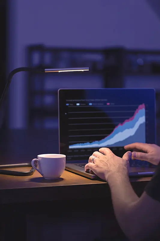 Image showing a person engaged in online learning on a laptop, surrounded by books and study materials, with the text "Embracing Lifelong Learning: Strategies for Continuous Growth and Success"